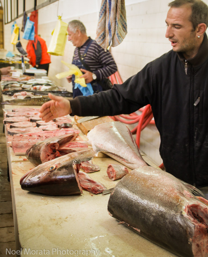 Split, Croatia fish market, a vendor is showing the different cuts