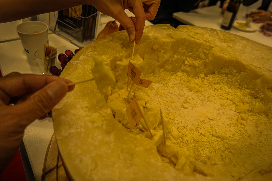 Eating from the Parmigiana wheel at the Fancy Food Show