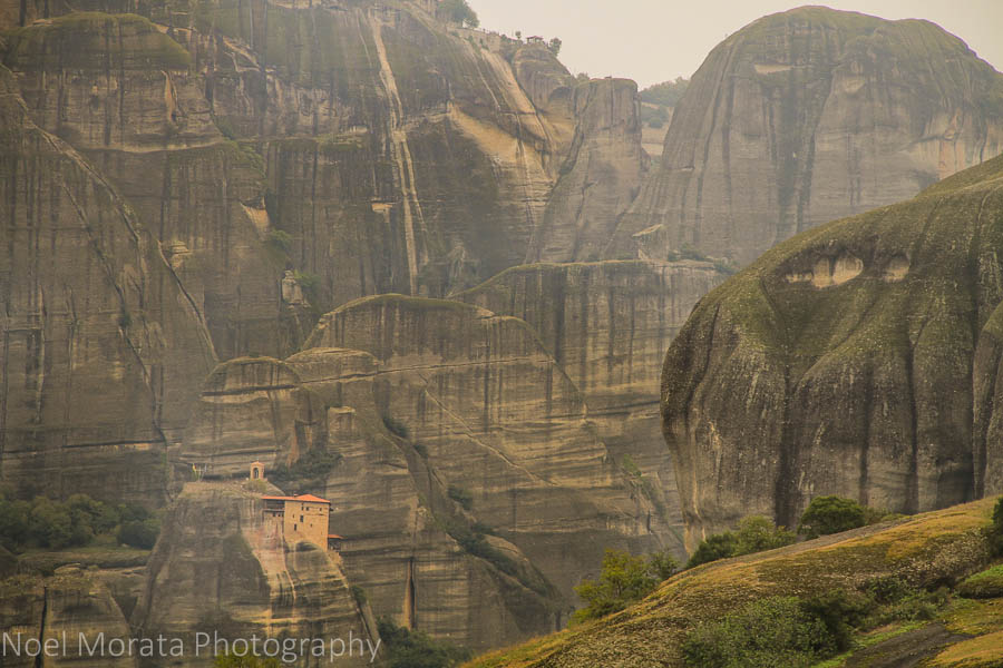 A lonely monastery dwarfed by huge mountains in Meteora