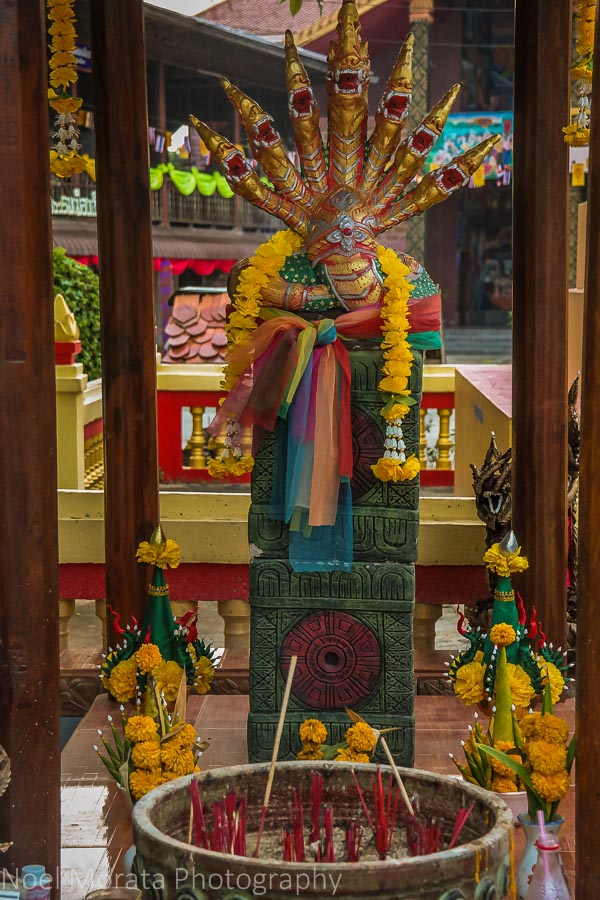 A shrine with flower offerings at Chiang Khan Wat