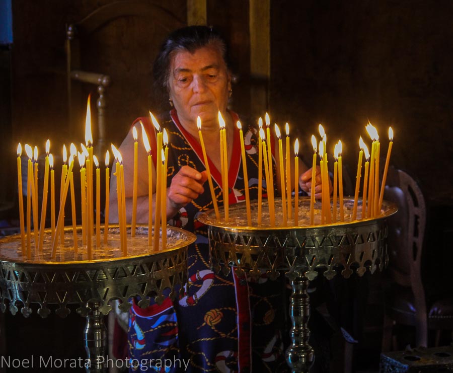 Lighting candles at the Church of the Trimartyri in Chania, Crete