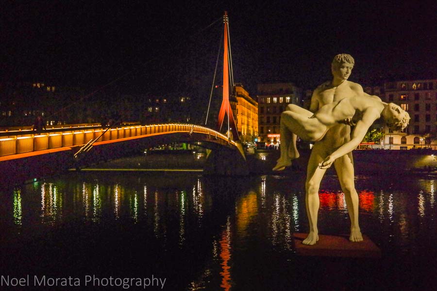 Drammatic sculpture at the Saone river, Lyon, France at night time