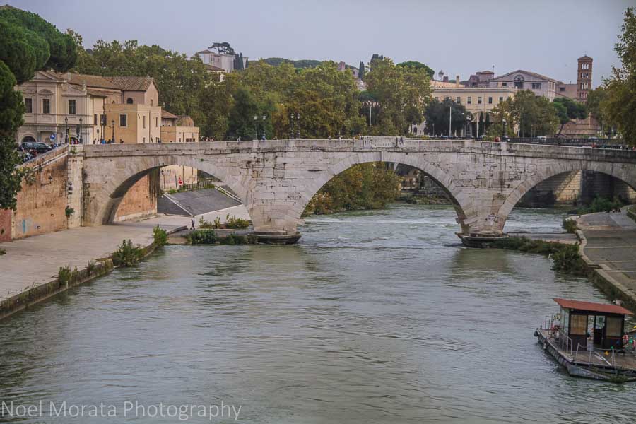 A beautiful stone bridge connecting Isola Tiberina to Trastevere in Rome