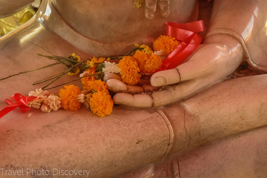 flowers and stone buddha Visiting Wat Phra That Doi Suthep