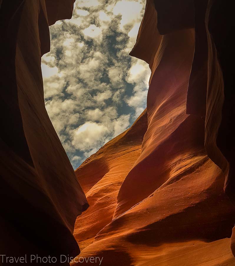 Clouds and blue skies looking up in lower Antelope Canyon