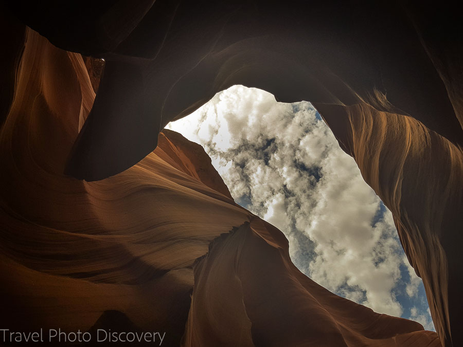 Clouds and blue skies looking up in lower Antelope Canyon