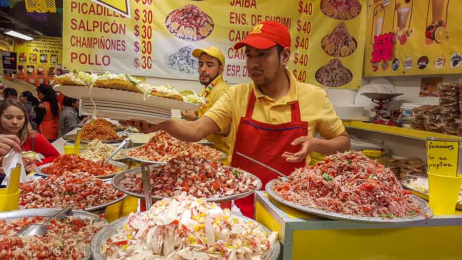 Touring Mexico City Tours by Locals visiting a local market and ceviche stalls