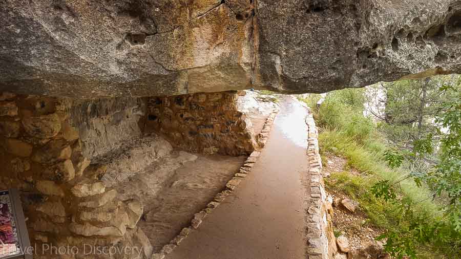 Walking through cliff dwellings at Walnut Canyon National Monument 