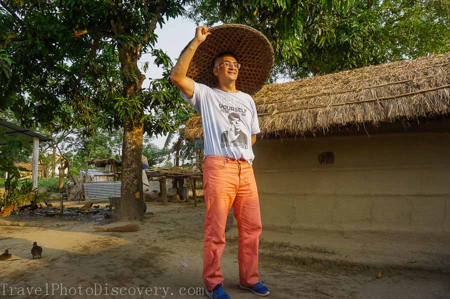 Trying a hat at a local village outside Chitwan National Park 