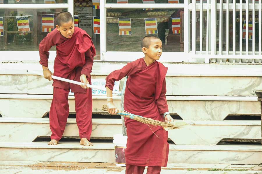 Daily chores with young monks cleaning the grounds of a monastery in Lumbini