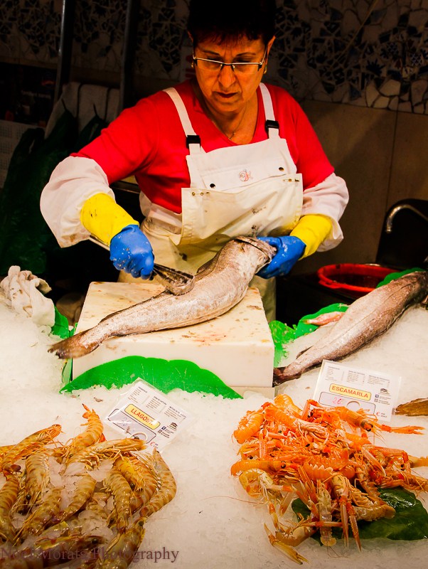 fishmonger at a public market in Barcelona