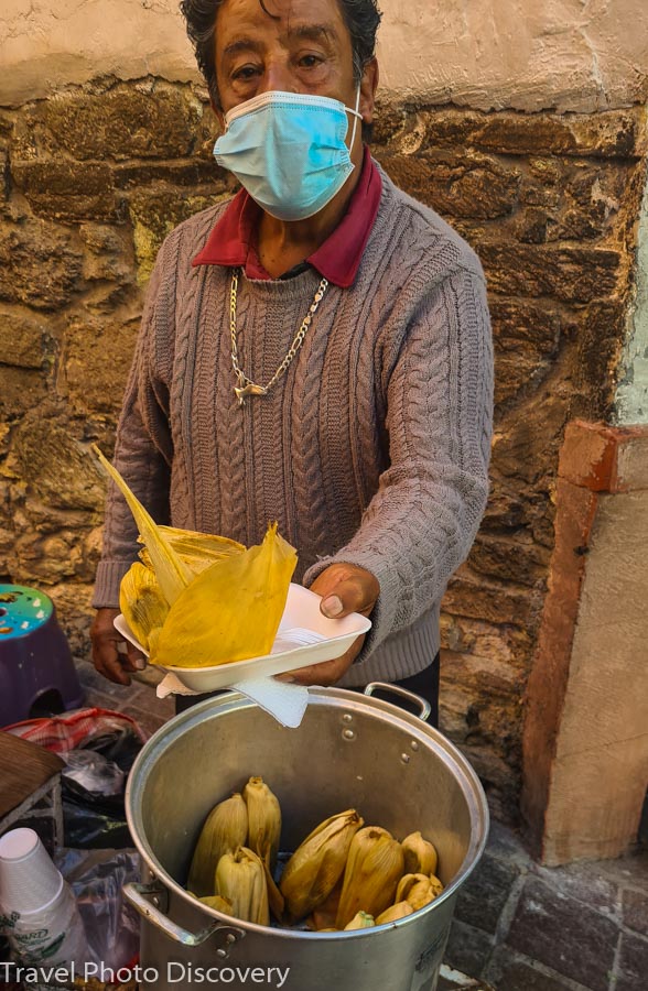 Trying some delicious and cheap tamales from a local street food vendor