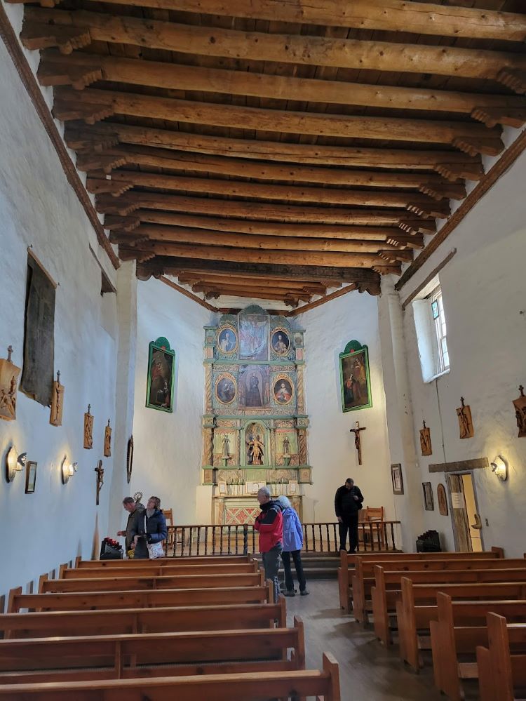 Explore the Loretto Chapel with its mysterious spiral staircase